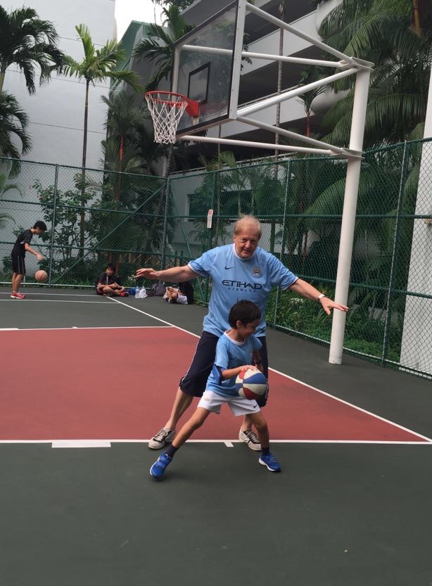 Mike keeping active by playing basketball with his son